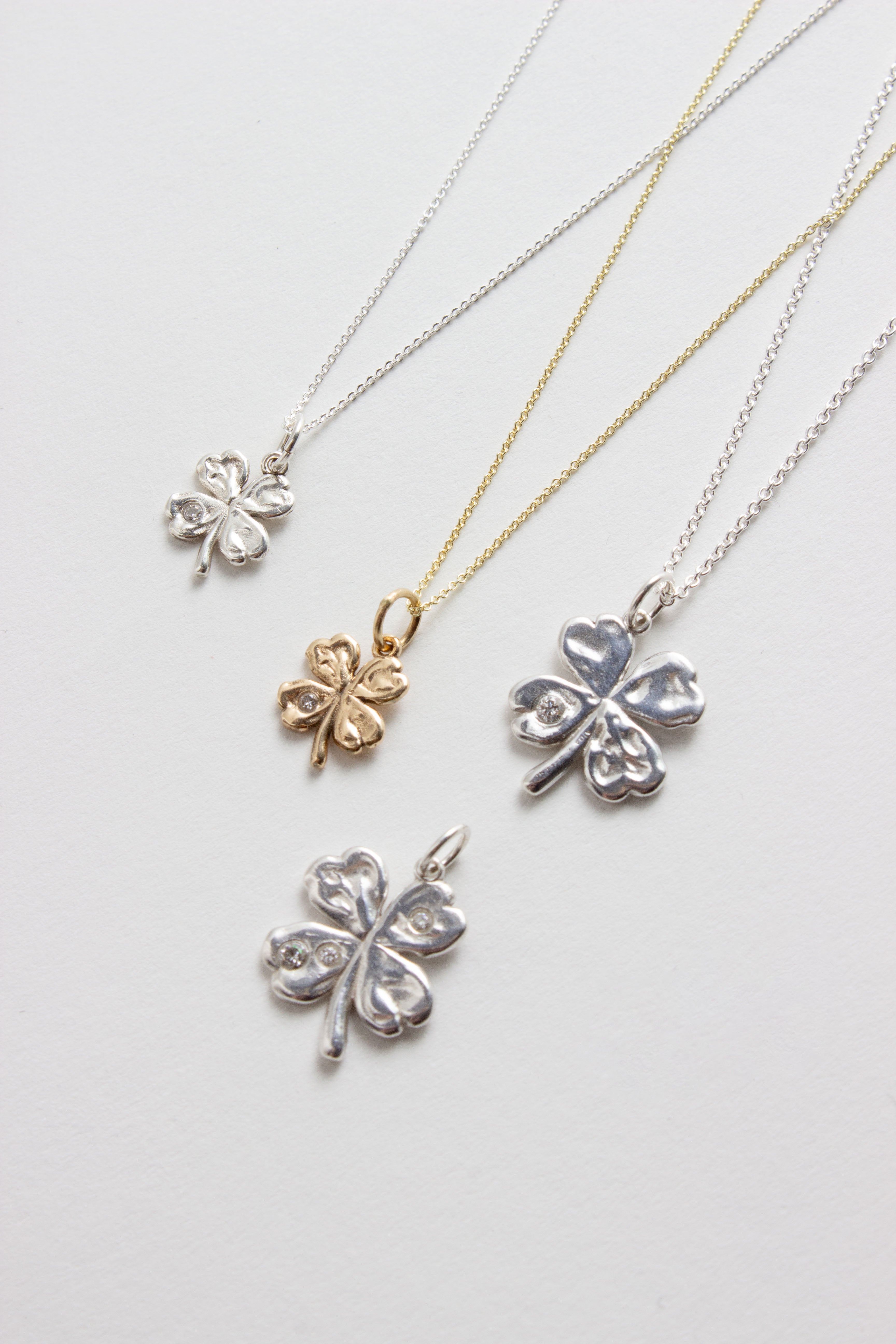 Aida lucky clover pendants in silver and gold with diamonds
